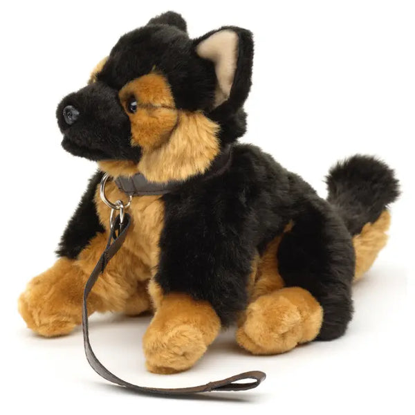 Plush German Shepherd dog toy with a leash on a white background